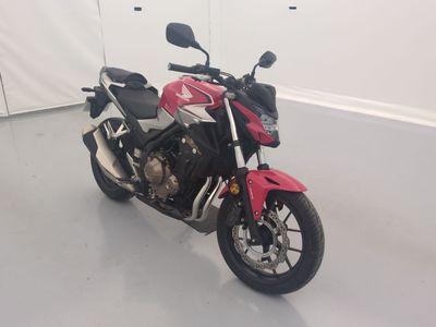 a red and white motorcycle parked in a room