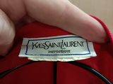 a picture of a person holding a label on a red jacket