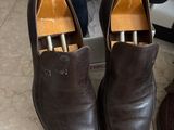 pair of men ' s shoes sitting on top of a box next to a pair of shoes