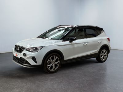 a white car is parked in a room with a white wall