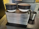 bowls and pans are stacked on top of each other on a counter