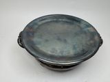 a silver plate with a handle on a white table