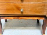 a small wooden table with a drawer on top of it