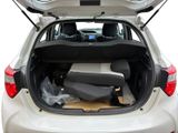 the back of a car with its trunk open and a seat in the trunk