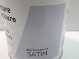 a can of paint sitting on a white table