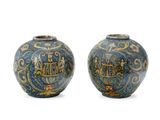 pair of blue and yellow vases with designs on them on a white background