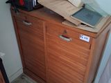 a microwave oven sitting on top of a wooden cabinet