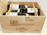 bottles of wine are in a wooden box on a table
