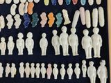 a lot of small white figurines in a wooden box
