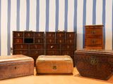 three chests and a chest of drawers in a room