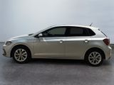 the silver car is parked on the concrete floor in the room
