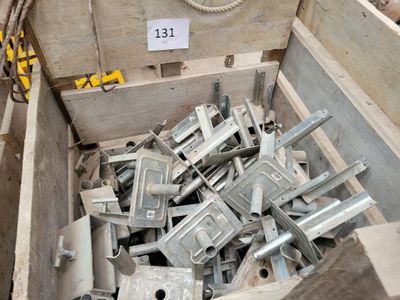 a wooden box filled with assorted pieces of metal