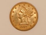 a close up of a gold coin with a woman ' s head on it
