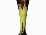 a black and yellow vase sitting on a white surface