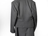 an image of a suit on a hanger on a wall
