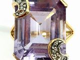 an image of a ring with a purple stone and a crescent