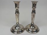 pair of silver plated candlesticks on a white background