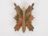 an image of a gold butterfly brooch on a white background