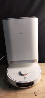 a white air purifier sitting on a wooden table
