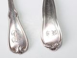 two spoons that are sitting next to each other on a table