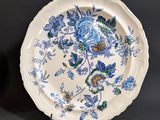 a white plate with blue and green flowers on it
