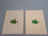 two notebooks with drawings of a christmas tree and birds on them