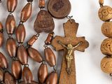 a close up of a wooden rosary with a wooden cross on it