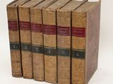 a set of five old books sitting on top of each other