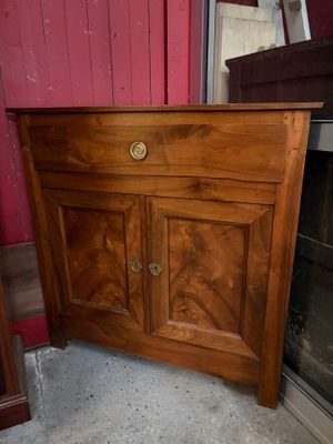 a wooden cabinet with a drawer on top of it