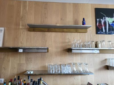 un bar avec plein de bouteilles et de verres sur les étagères