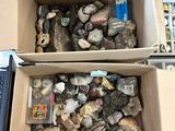 two boxes with rocks in them sitting on a table