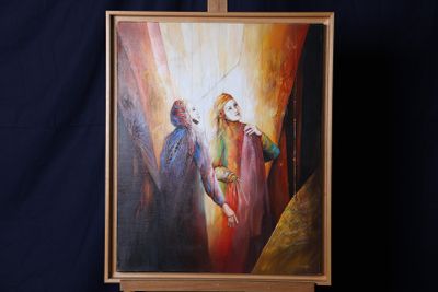 une peinture à l'huile représentant Jésus et Marie posée sur un chevalet