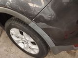 a close up of a car ' s tire on the side of the road