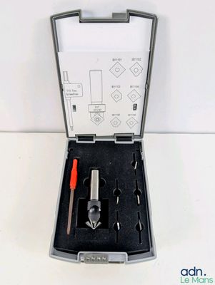 a box with tools in it on a white surface