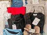 several pairs of men ' s pants and sandals are laid out on a table