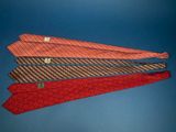 three ties are stacked on top of each other on a blue background