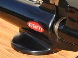 a black machine with a red bugatti sticker on it