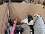 a cardboard box filled with many items in a warehouse