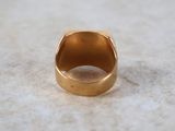 a close up of a gold ring on a marble surface