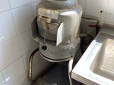 a dirty sink in a dirty bathroom with a dirty faucet