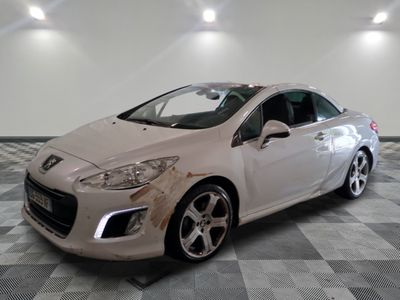 a picture of a white car that is in a garage