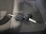 a car key that is laying on the seat of a car
