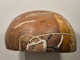 a brown and black hat with a snake on it