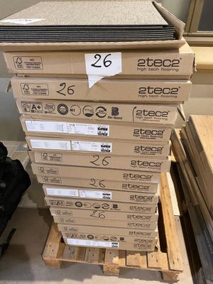 a stack of boxes sitting on a pallet in a room