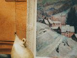 a picture of a painting and a vase sitting on a table