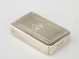 an antique silver cigarette case with a lion on the front