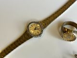 a watch and a ring sitting on a table