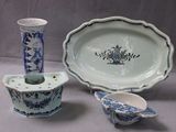 three pieces of blue and white pottery sitting on a table