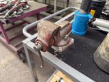 a metal work bench with tools on it in a workshop