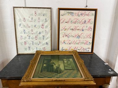 two framed pictures sitting on a table next to each other